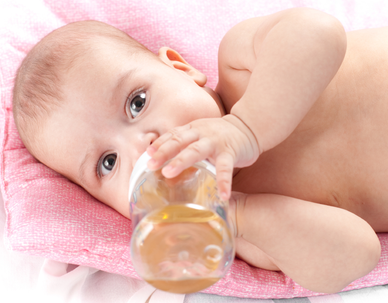 3 months adorable  baby girl drinking from plastic bottle in her