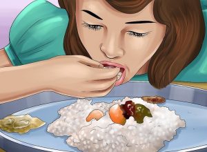 girl eating rice with fingers