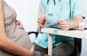 pregnant woman talking to doctor 