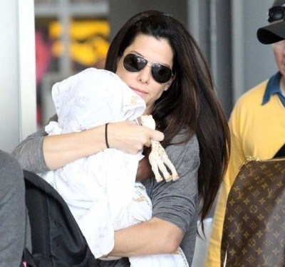 July 14, 2010: Sandra Bullock spotted with her adopted son, Louis Bardo Bullock, arriving at New Orleans Airport in New Orleans, Louisiana.Credit: INFphoto.com Ref: infusla-176|sp|