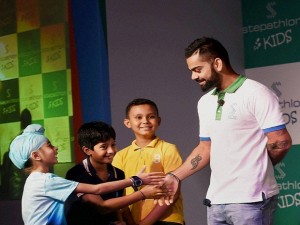 New Delhi: Cricketer Virat Kohli interacts with children at the launch of Stepathlon Kids, a company on building a healthy lifestyle for children, in New Delhi on Tuesday. PTI Photo by Subhav Shukla (PTI6_28_2016_000062A)